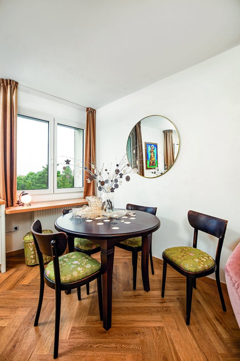 Nový kulatý rozkládací stůl se krásně snoubí se starými židlemi z místního bazaru. Jejích dobovou patinu jsme nechali v původním stavu. Proměnou prošli jen podsedáky.