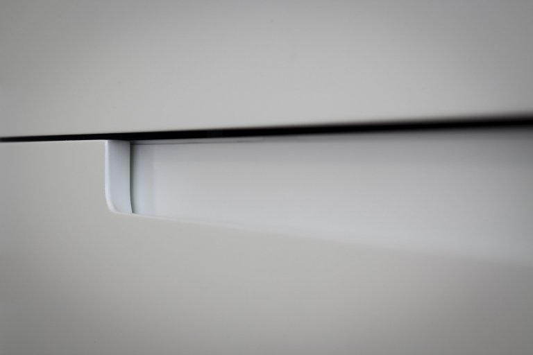 Kuchyňská linka s&nbsp;velkorysým ostrůvkem z materiálu Corian. Netradičním prvkem kuchyně je uzavíratelná část linky, díky které bude kuchyň vypadat uklizeně…