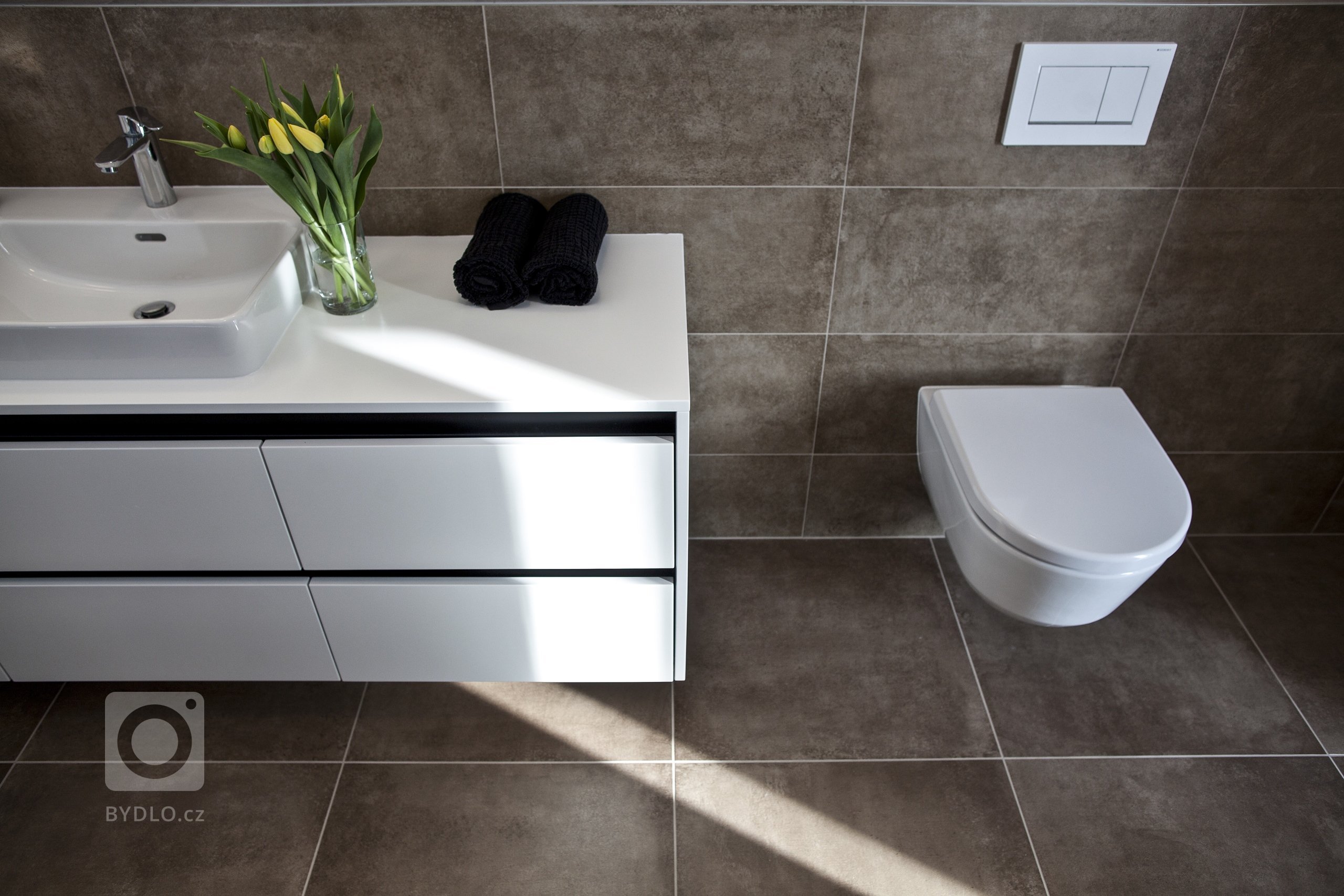 V celém domě se prolínají přírodní materiály s černými kovovými prvky a detaily s bílými stěnami a dveřmi. Industriální ráz podtrhují přiznané betonové stropy…